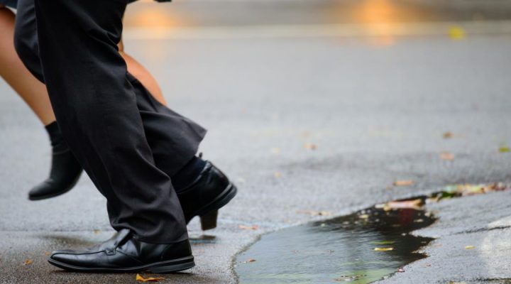 professionals-stepping-across-puddles-in-cbd