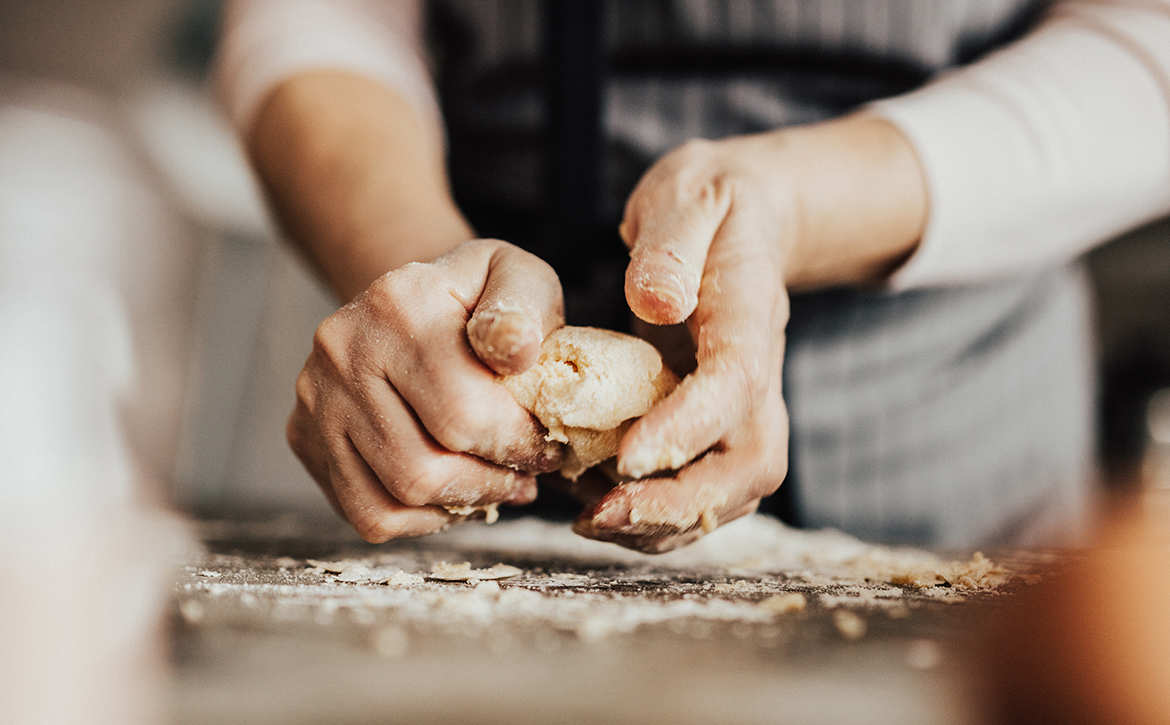 Close-up-of-woman's-hands-kneading-dough